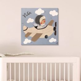 Habitación infantil con cuadro personalizado de niño en avión